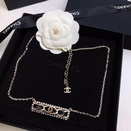 CHANEL 26S CHANEL CC LOGO CRYSTAL TRIM BAR PENDANT NECKLACE WITH BLACK LEATHER IN GOLD METAL 633315