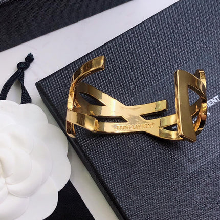 YSL 26S CRISS CROSS OPEN CUFF BRACELET IN GOLD TONE METAL 635064