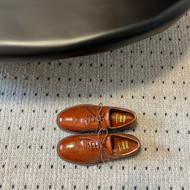 MIUMIU 26S LACE-UP BROGUE LOAFERS IN RUST ORANGE PATENT CALFSKIN