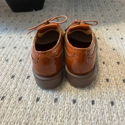 MIUMIU 26S LACE-UP BROGUE LOAFERS IN RUST ORANGE PATENT CALFSKIN