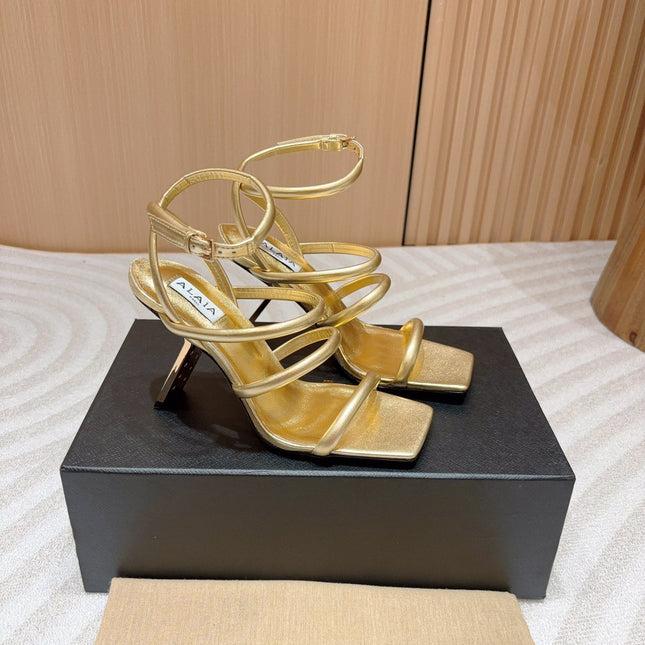 ALAIA THREE-STRAPS HIGH HEEL SANDALS IN GOLDEN PATENT LAMBSKIN