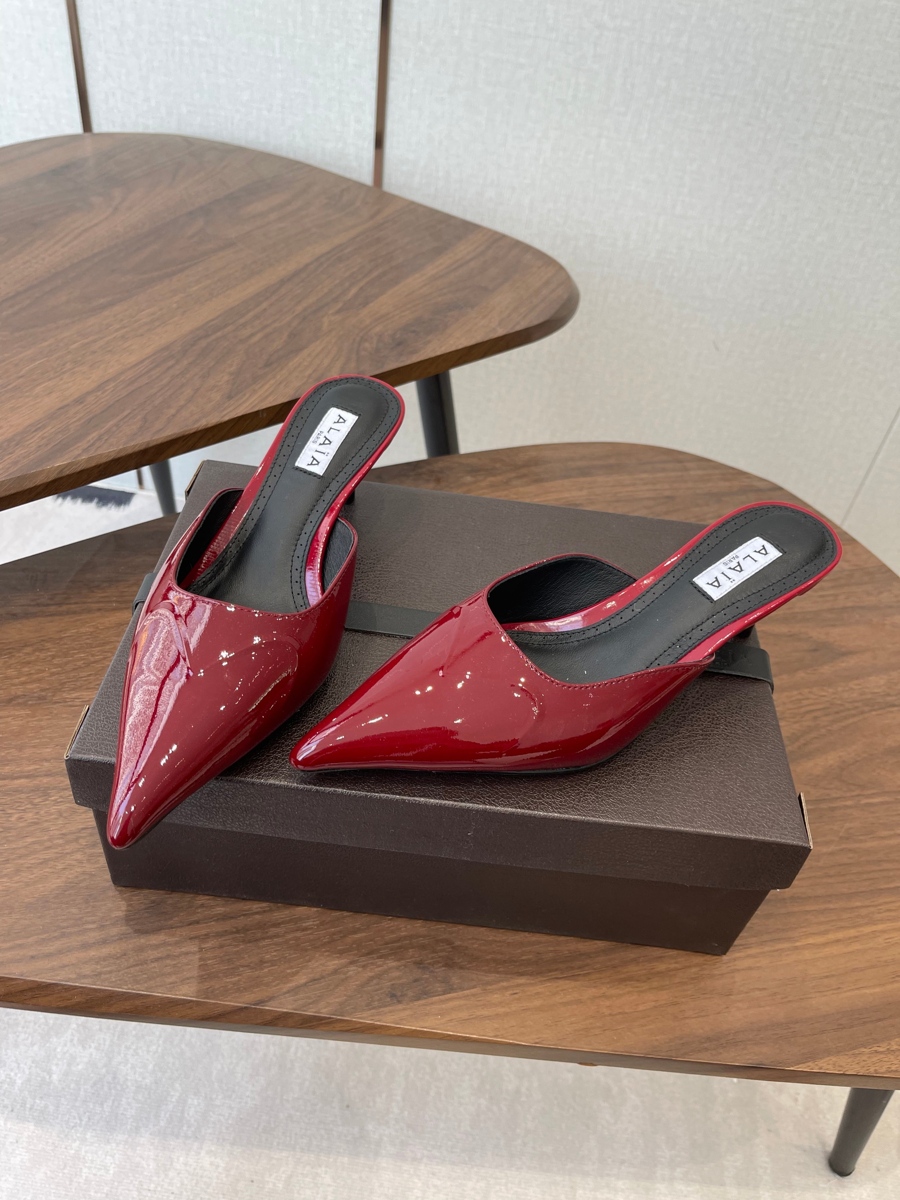 ALAIA 26S HEELED MULES 50 MM IN DARK RED GLOSSY CALFSKIN