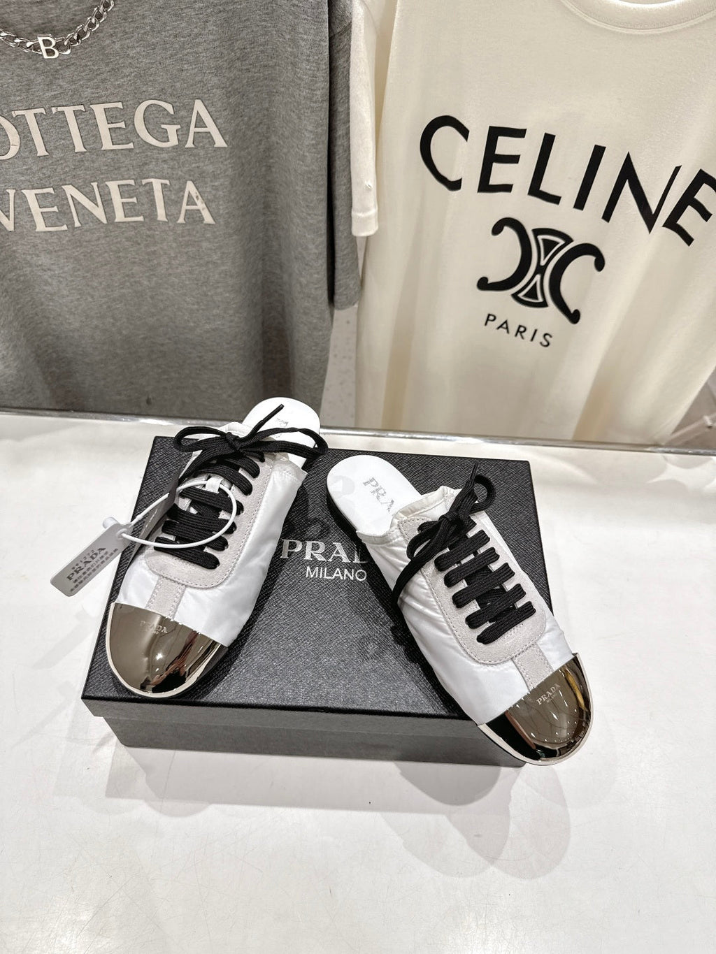 PRADA 25S MULES IN WHITE WITH METAL TOECAP