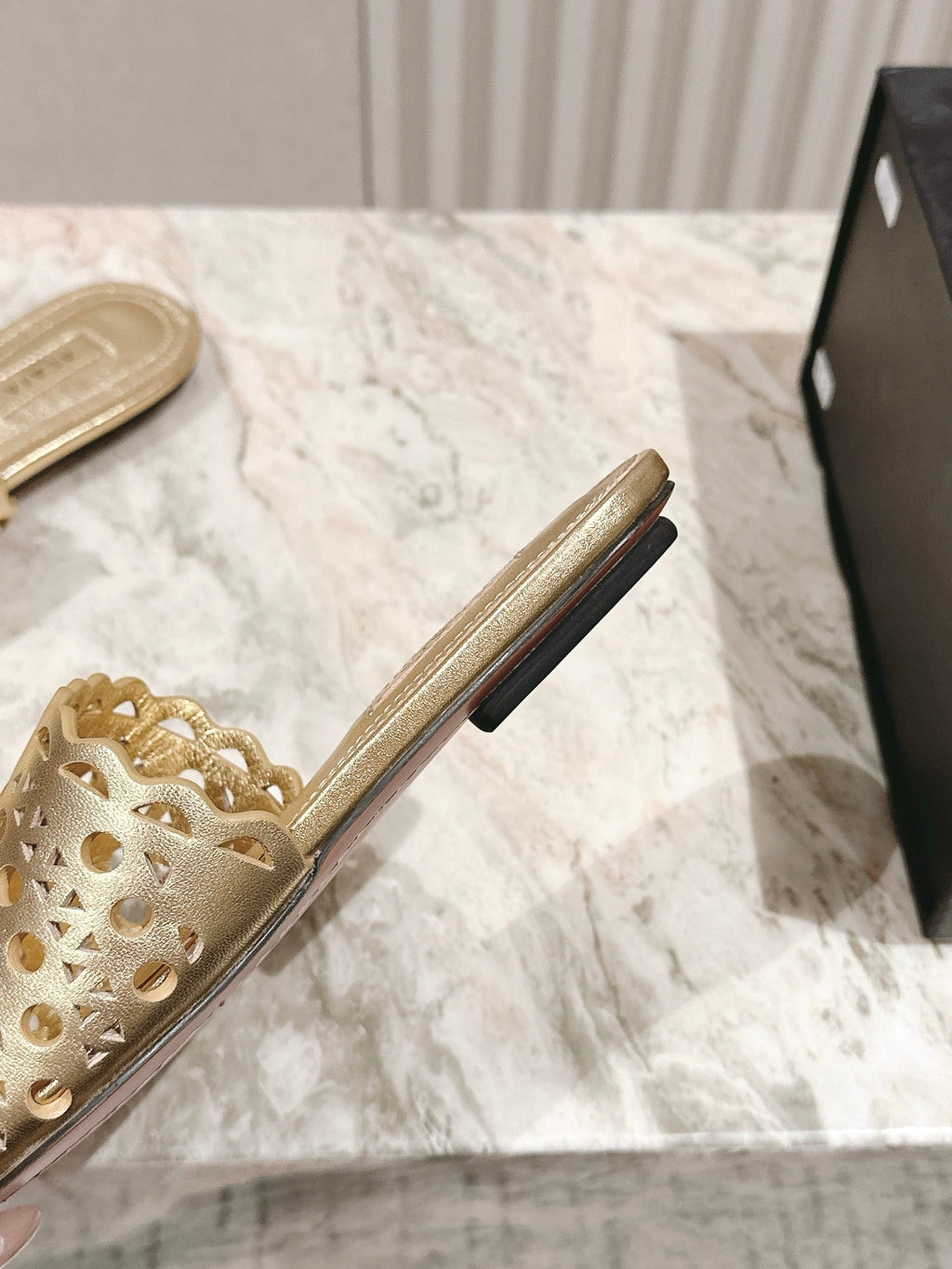ALAIA PERFORATED SLIDE SANDALS 25S IN LIGHT GOLD LAMBSKIN
