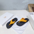 THE ROW 26S THONG SANDALS IN BLACK RUBBER  WITH GOLD YELLOW STRAPS