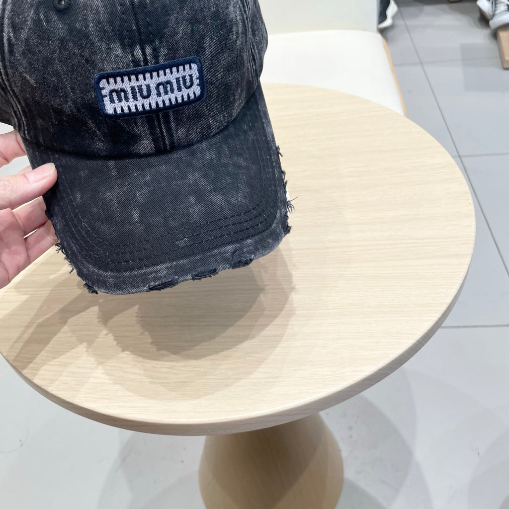 MIUMIU DISTRESSED FABRIC BASEBALL CAP IN BLACK WITH EMBROIDERED LOGO