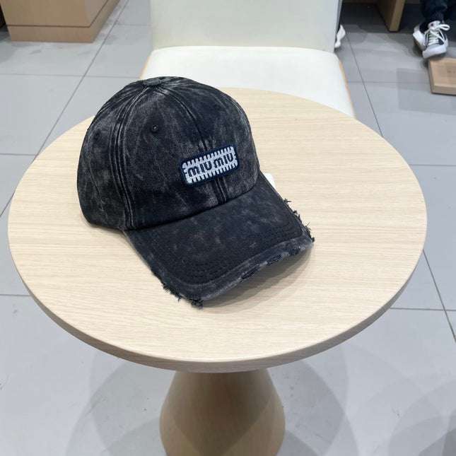 MIUMIU DISTRESSED FABRIC BASEBALL CAP IN BLACK WITH EMBROIDERED LOGO