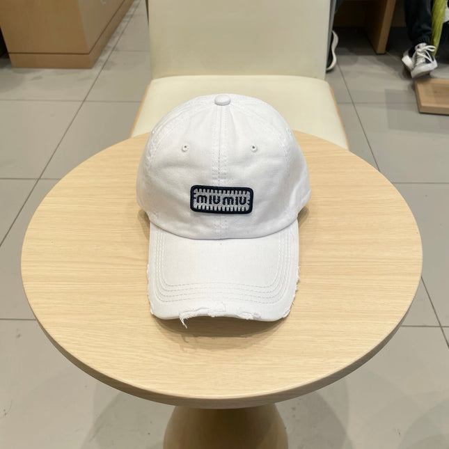 MIUMIU DISTRESSED FABRIC BASEBALL CAP IN WHITE WITH EMBROIDERED LOGO
