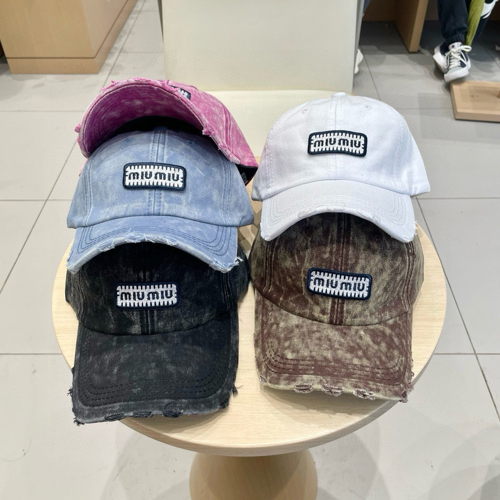 MIUMIU DISTRESSED FABRIC BASEBALL CAP IN BROWN WITH EMBROIDERED LOGO