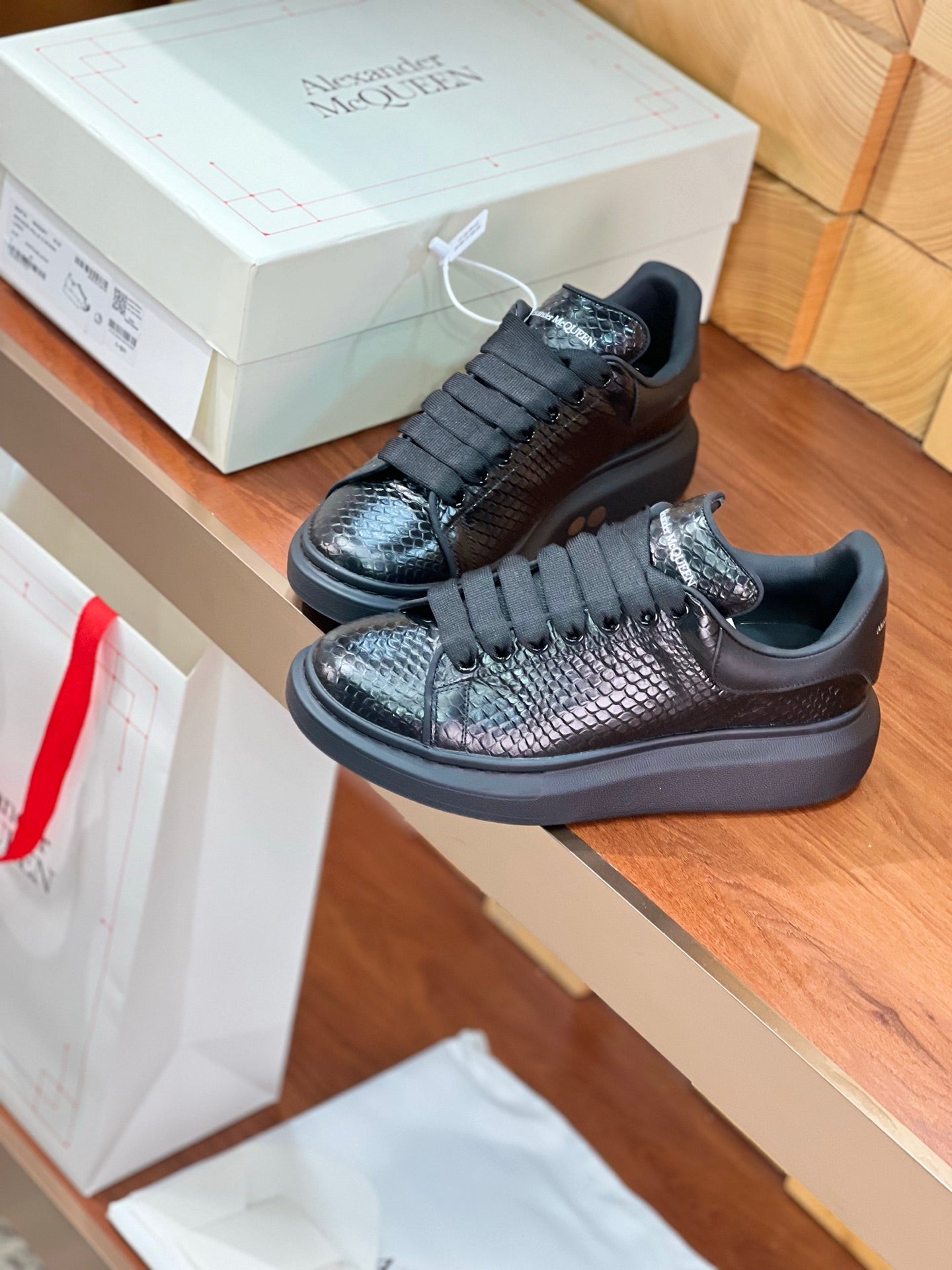 OVERSIZED SNEAKERS IN BLACK GLOSSY CALFSKIN SNAKE-EFFECT