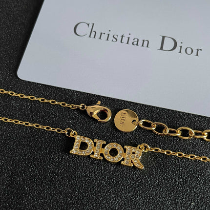 CD 26S PAVE LOGO LETTER NECKLACE IN GOLD TONE METAL 631806