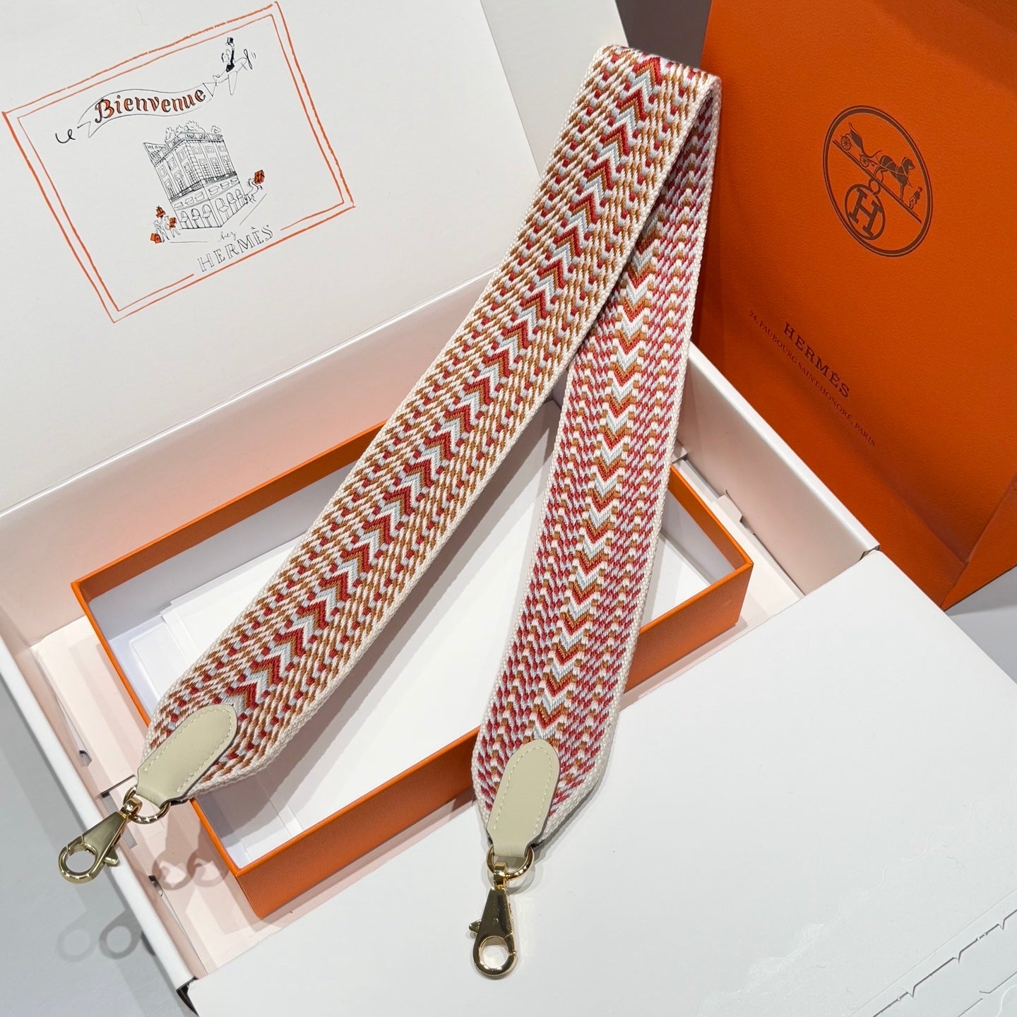 25S HERMES BAG STRAP ORANGE AND RED PATTERN 85 IN CANVAS GOLD HARDWARE