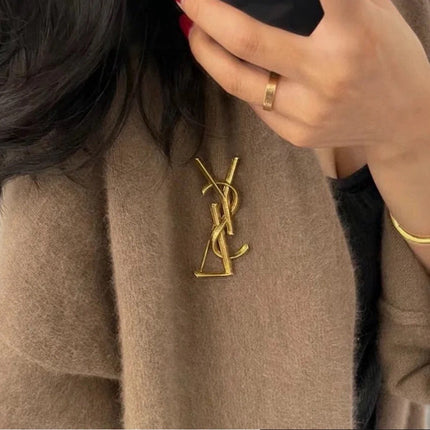 YSL 26S TEXTURED MONOGRAM BROOCH IN ANTIQUE GOLD TONE METAL