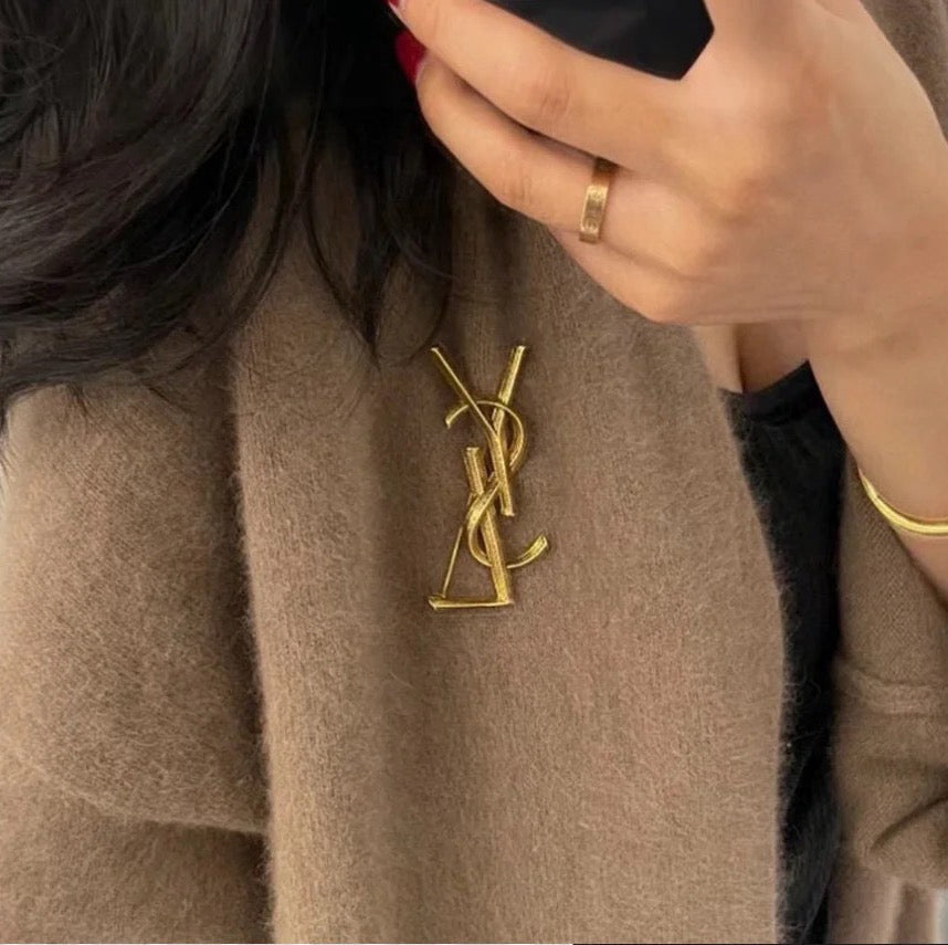 YSL 26S TEXTURED MONOGRAM BROOCH IN ANTIQUE GOLD TONE METAL