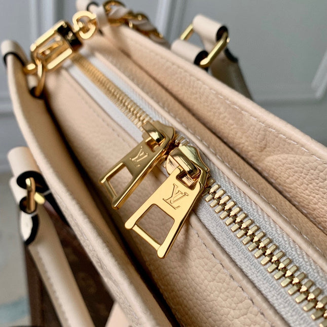 ONTHEGO EAST WEST BAG 25 IN BEIGE MONOGRAM EMBOSSED COWHIDE