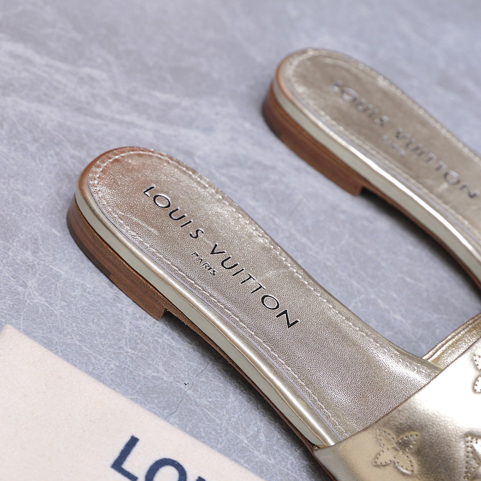 LV 26S FLAT SLIDE SANDALS IN GOLD CALFSKIN EMBOSSED MONOGRAM LOGO