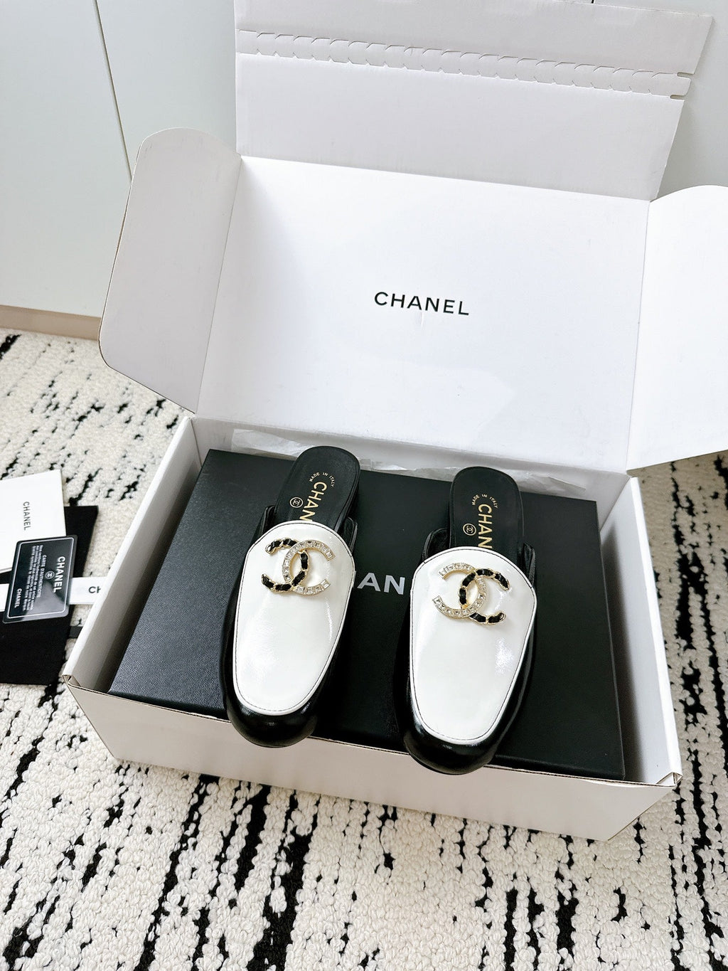CC FLAT MULE IN WHITE AND BLACK CALFSKIN HARDWARE WITH ROCK MIX CHAIN