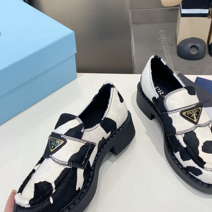 PRADA 26S LOAFERS IN WHITE AND BLACK COW PRINT PONY HAIR