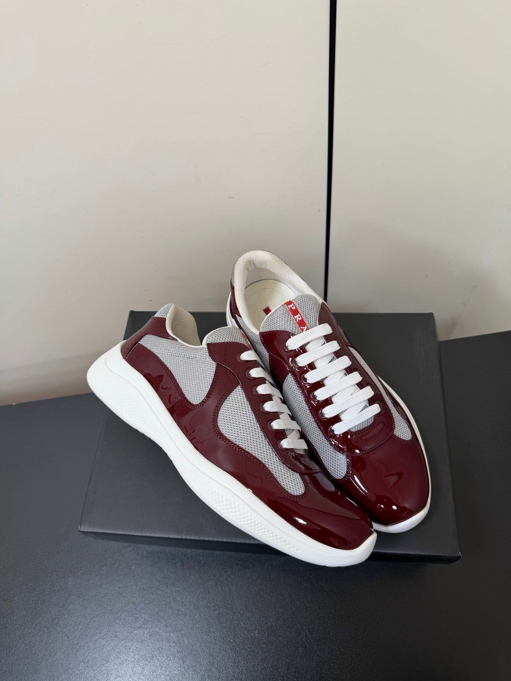 PRADA 26S SNEAKERS IN BURGUNDY RED PATENT CALFSKIN AND WHITE MESH