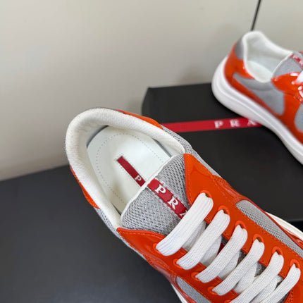 PRADA 26S SNEAKERS IN RED ORANGE PATENT CALFSKIN AND WHITE MESH