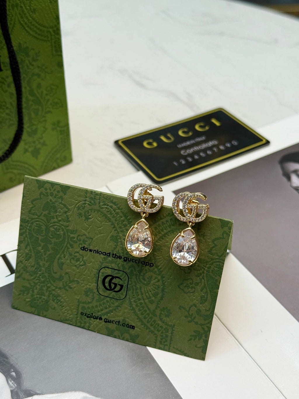 GUCCI 26S INTERLOCKING GG CRYSTAL TEARDROP EARRINGS IN GOLD TONE METAL 621443