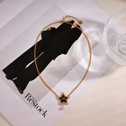 CD 26S PEARL STAR LOGO PENDANT NECKLACE IN GOLD TONE METAL