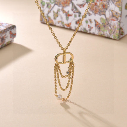 CD 26S PEARL CHAIN DROP LOGO NECKLACE IN GOLD TONE METAL WITH WHITE RESIN PEARL & CRYSTAL 631060
