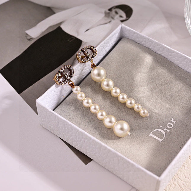 CD 26S PAVE LOGO PEARL DROP EARRINGS IN GOLD TONE METAL 631791
