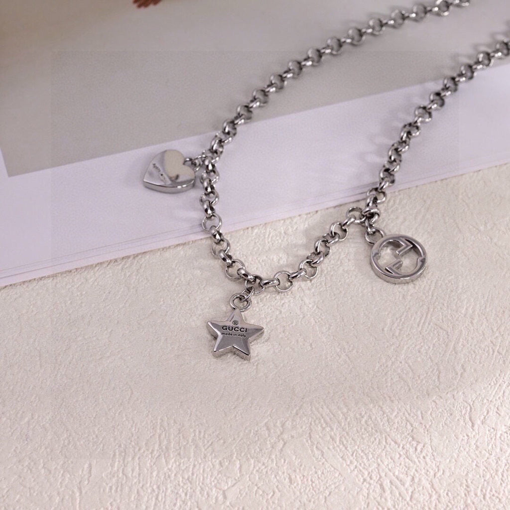 GUCCI 26S INTERLOCKING G LOGO STAR HEART MULTI CHARM CHAIN BRACELET IN SILVER TONE METAL