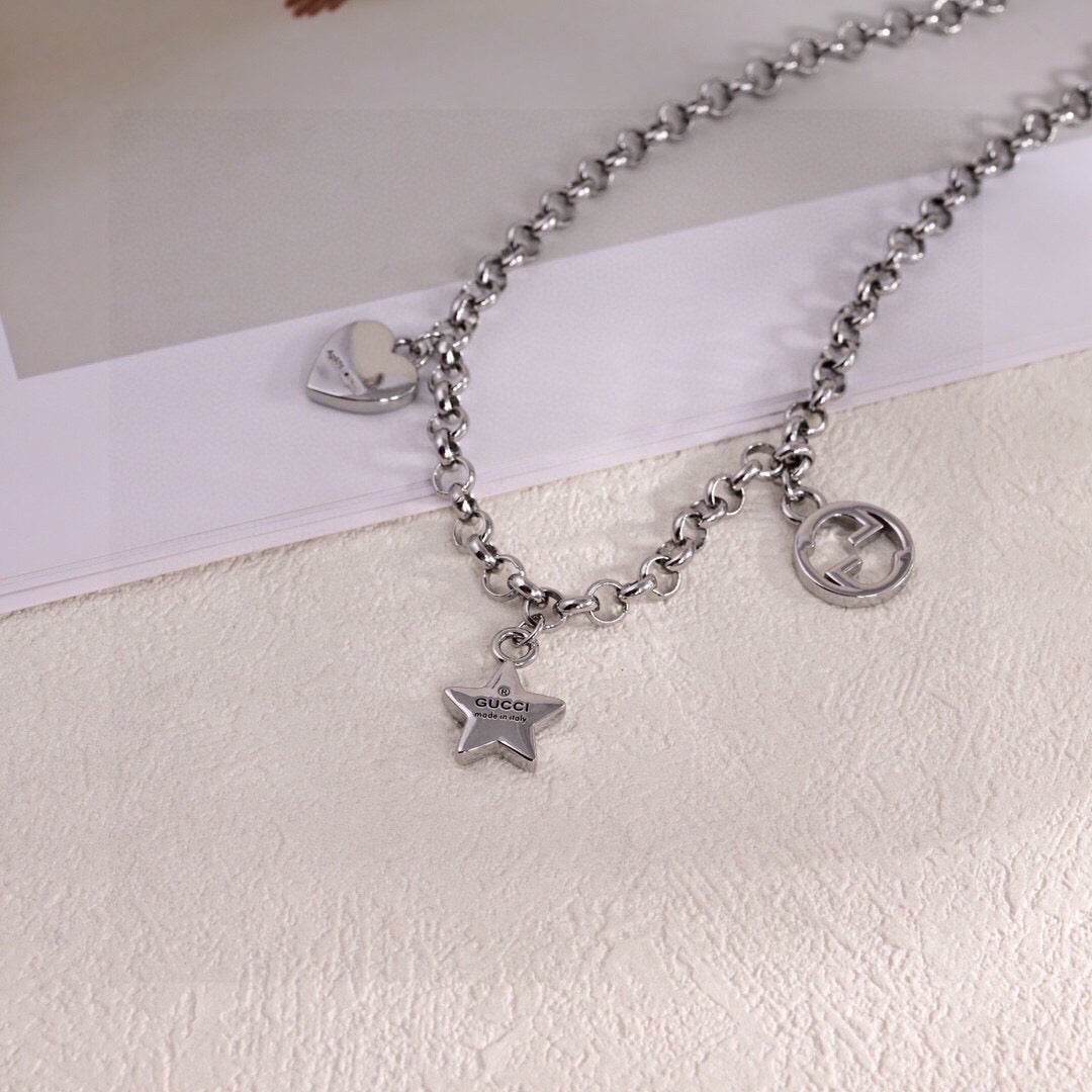 GUCCI 26S INTERLOCKING G LOGO STAR HEART MULTI CHARM CHAIN BRACELET IN SILVER TONE METAL