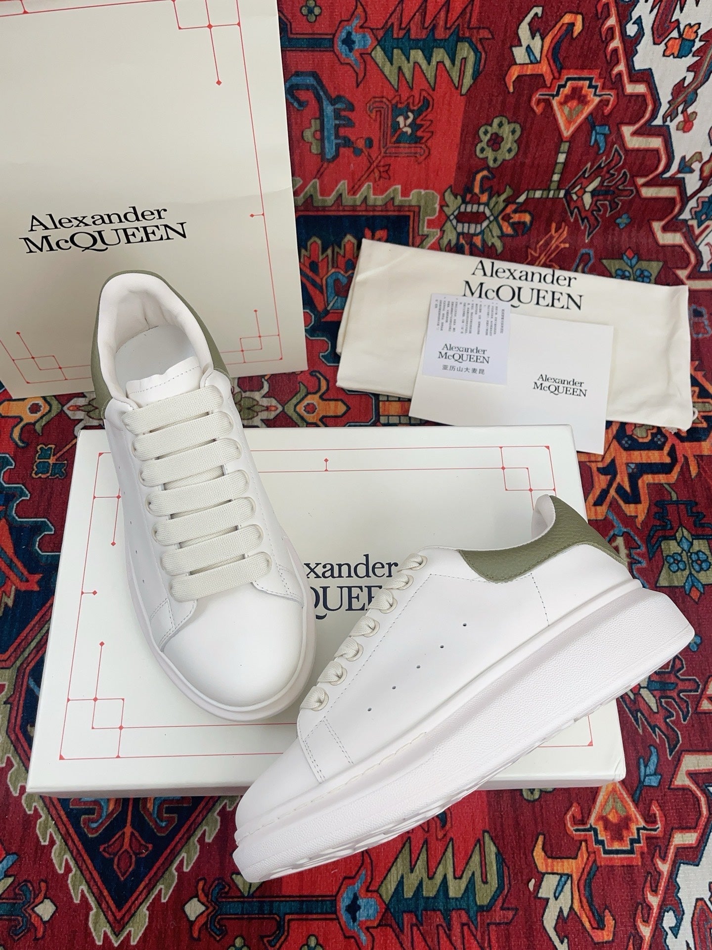 OVERSIZED SNEAKER IN WHITE CALFSKIN WITH EMBOSSED OLIVE GREEN HEEL TAB