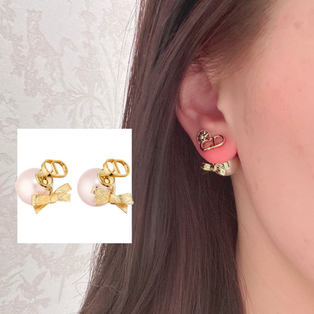 CD 26S PEARL BOW DROP EARRINGS IN GOLD TONE METAL 644484