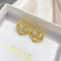 CD 26S CRYSTAL CHAIN LOGO STUD EARRINGS IN GOLD TONE METAL 645655