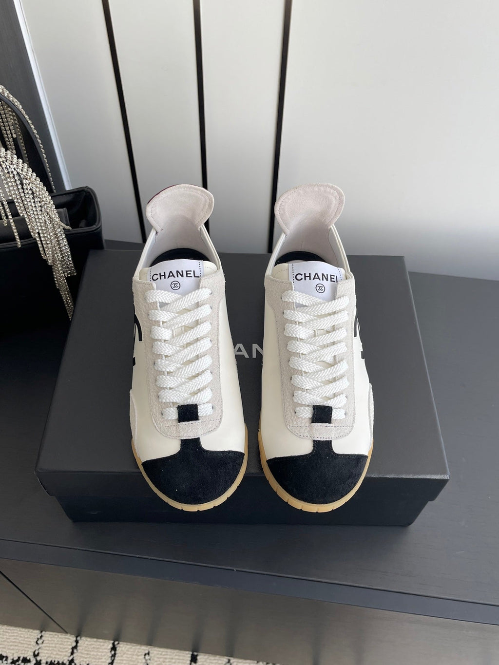 CHANEL LOW-TOP SNEAKERS IN BLACK AND WHITE CALFSKIN MIX SUEDE