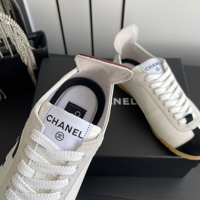 CHANEL LOW-TOP SNEAKERS IN BLACK AND WHITE CALFSKIN MIX SUEDE