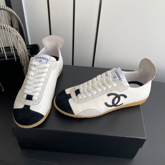 CHANEL LOW-TOP SNEAKERS IN BLACK AND WHITE CALFSKIN MIX SUEDE