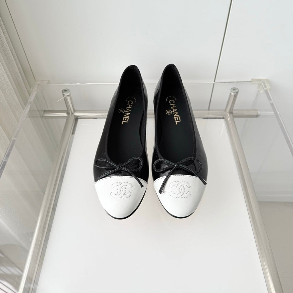 CHANEL 26S BALLET FLATS IN BLACK CRACKED CALFSKIN WITH WHITE TOE CAP AND BOW