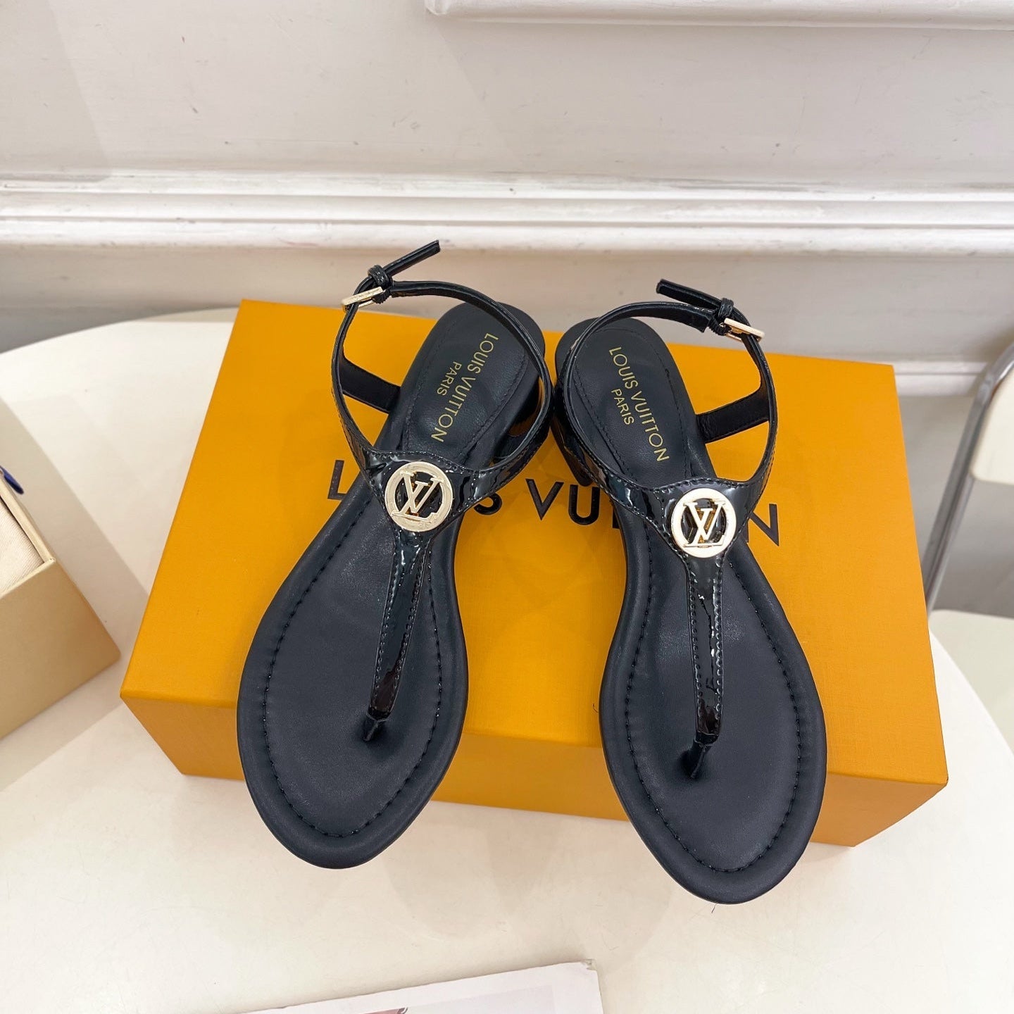 LV SUNKISS T-STRAP SANDALS IN BLACK CALFSKIN GOLD-TONE ACCESSORY.
