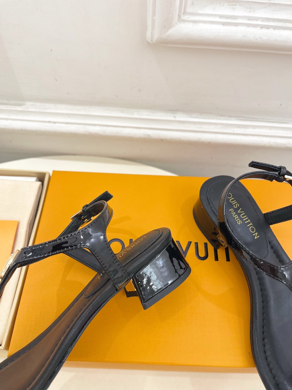 LV SUNKISS T-STRAP SANDALS IN BLACK CALFSKIN GOLD-TONE ACCESSORY.