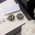 GUCCI 26S DOUBLE G LOGO MULTICOLOR CRYSTAL FLORAL STATEMENT STUD EARRINGS IN AGED GOLD TONE METAL 629028